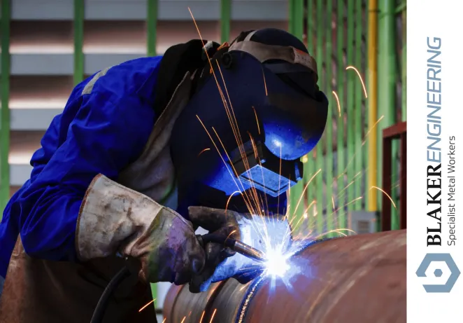 Welder working on metal pipe at blaker engineering