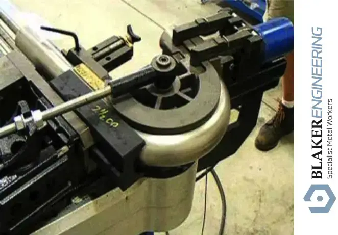 Tube manipulation machine in a workshop with metal parts and tools