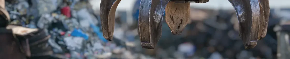 Crane lifting scrap metal blaker